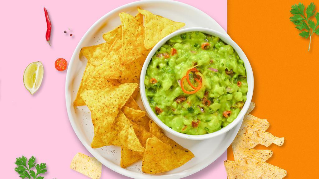 Chips And Guacamole · A heaping scoop of fresh homemade guacamole and warm tortilla chips.