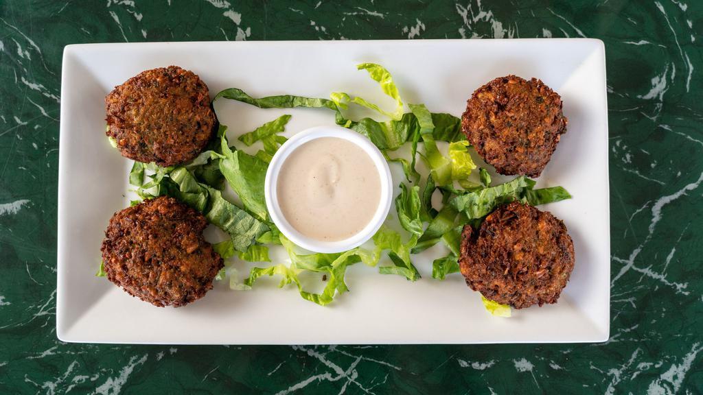 Falafel Dinner · Chickpeas, onions, celery, green peppers, garlic, parsley, and herbs served with tahini sauce over a bed of hummus.