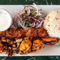 Mixed Chicken Grill · Chicken adana, chicken gyro, chicken shish, served with rice, grilled tomatoes, and peppers.