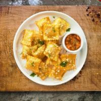 Crunchy Ravioli · (Vegetarian) Cheese-filled ravioli breaded and fried until golden brown. Served with housema...