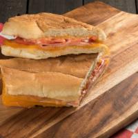 Dominican Panini Bundle · Cooked ham, butter, mayonnaise, ketchup, and green tomatoes. Served with your choice of Coca...
