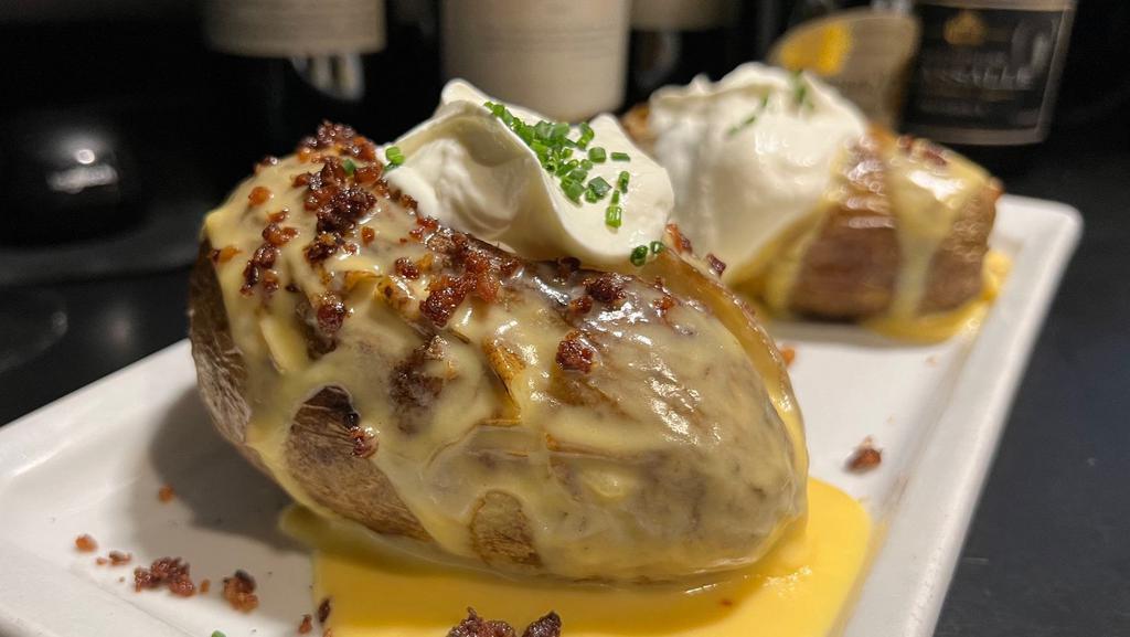 Loaded Baked Potato · Crumbled bacon, sour cream, cheddar cheese sauce, scallions