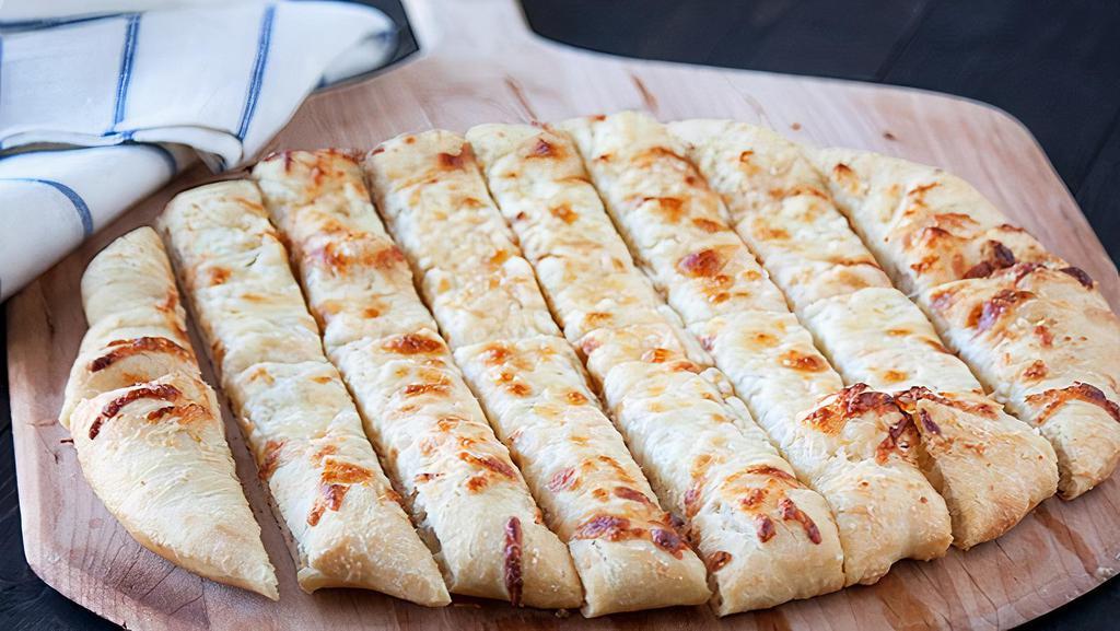 Cheesy Bread Sticks · Cheesy garlic butter breadsticks served with tomato dipping sauce.