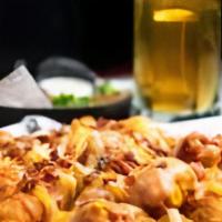 Terror Tots! · Tater tots topped with jalapenos, cheese, & drizzled with sriracha.