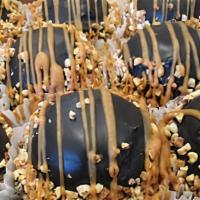 Peanut Butter Explosion · A chocolate candy bar bottom. Topped with peanut butter ganache and a mound of chocolate mou...