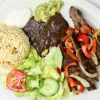 Bistec Encebollado · Grilled steak and sautéed veggies. Served with rice, beans, tomatoes green pepper, and two f...