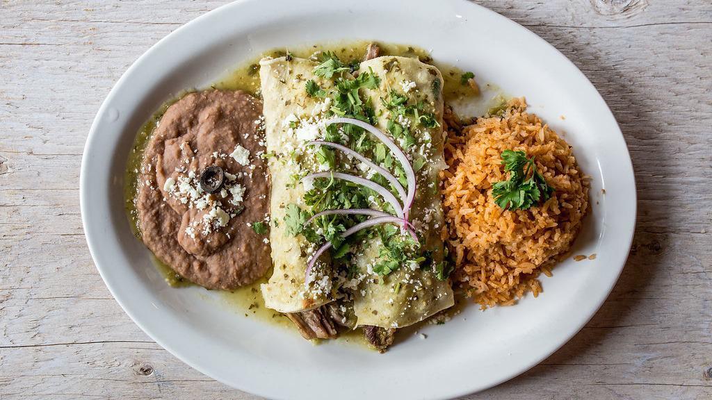 Enchiladas Verdes · Three chicken enchiladas topped with cheese sauce and a spicy green salsa. Served with rice and beans.