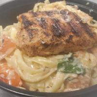 Salmon Alfredo · Served with homemade Alfredo sauce, spinach and plum tomatoes.