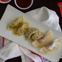 Dumplings Sampler · Fried or steamed pork & shrimp, chicken lemongrass, and vegetable dumplings with a side of g...