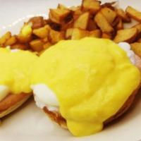 Eggs Benedict · 2 poached eggs on top of a toasted English muffin topped with hollandaise sauce.