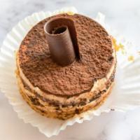 Tiramisu Cake Slice · Alternating layers of yellow cake and devil’s food cake soaked with espresso. Filled and ice...