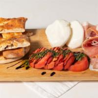 Burrata Board · Burrata, Prosciutto, Sliced Tomatoes with Pesto & Balsamic Glaze, Wood-Fired Piadina Bread.