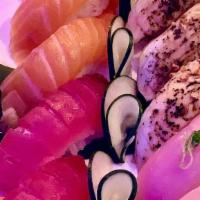 Quartet · 3 pieces of tuna, 3 pieces of salmon, 3 pieces of yellowtail, & 3 pieces of torched white tu...