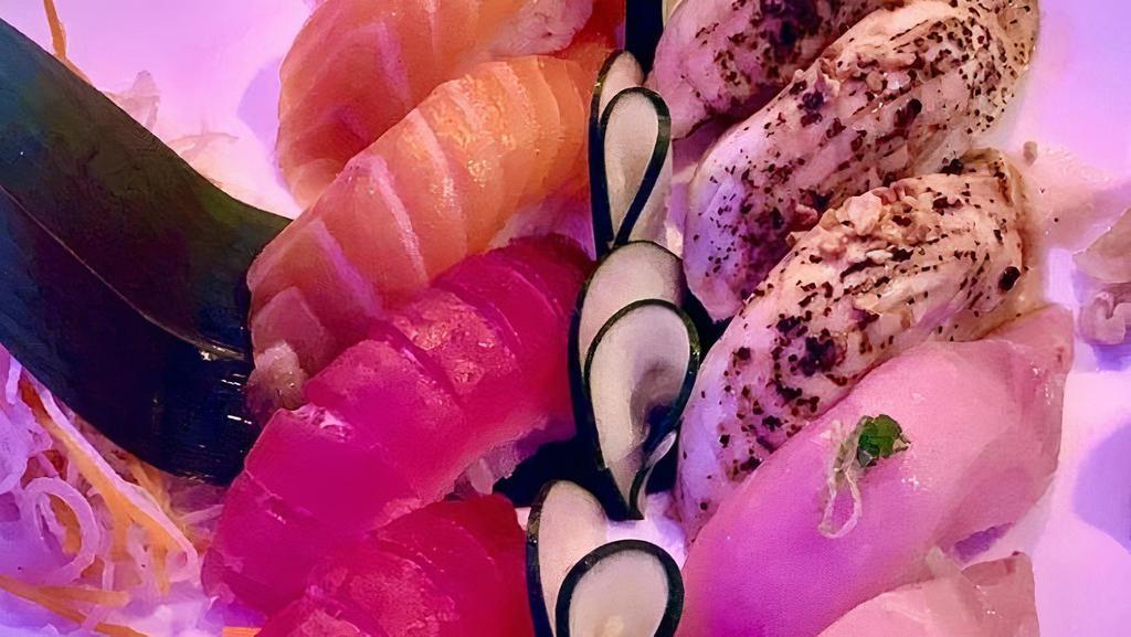 Quartet · 3 pieces of tuna, 3 pieces of salmon, 3 pieces of yellowtail, & 3 pieces of torched white tuna (with crispy garlic) sushi