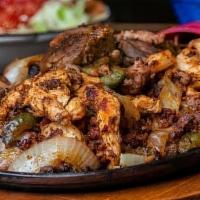Parrillada Mexicana · Carnitas (pork), chorizo (Mexican sausage), shrimp, chicken and steak, all seasoned and gril...