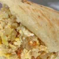 Arepa Perico · Scrambled eggs with tomatoes, onions, and shredded cheese.