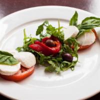 Caprese Salad · Fresh Mozzarella, fresh ripe tomatoes and roasted red peppers drizzled with balsamic vinaigr...