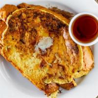 Portuguese Sweet Bread French Toast · Farm fresh eggs whipped until fluffy mixed with cinnamon and maple syrup topped with sweet c...