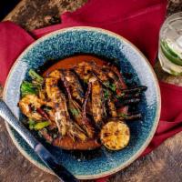 Diablo Shrimp · Charred citrus marinated shrimp, chipotle sauce, grilled green onions, and Mexican rice. (co...