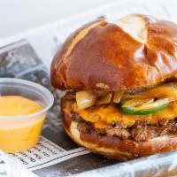 Philly Burger · Philly Pretzel Bun, Cheese Whiz, Fried Onions, Jalapeno Peppers