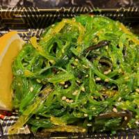 Seaweed Salad · Marinated seaweed with sesame seed garnished with cucumbers.