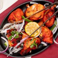 Chicken Makhani · Tandoori chicken cooked in butter sauce with fresh chopped tomatoes.
