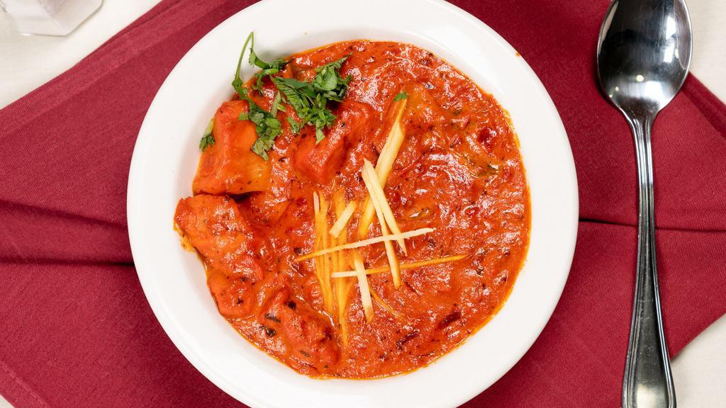 Achari Chicken  · Chicken cooked with onions, garlic, tomatoes, fresh chili pepper & flavored with pickled spices.