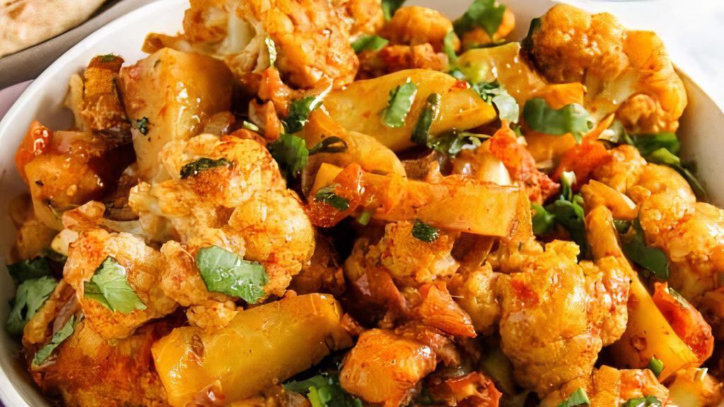 Aloo Gobi · Vegan, gluten-free. Steamed cauliflower with potatoes and tomatoes, flavored with Indian herbs and spices.