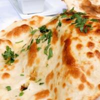 Tandoori Naan · Made with all-purpose white flour. Traditional white flour bread baked in our tandoor.
