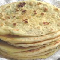 Sesame Naan · Made with all-purpose white flour. White flour bread baked in tandoor topped with sesame see...