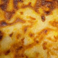 Pupusa Con Pollo Y Queso · A small-grilled tortilla stuffed with chicken and cheese.