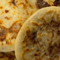 Pupusa Con Frijol Y Queso · A small-grilled tortilla stuffed with cheese and beans.