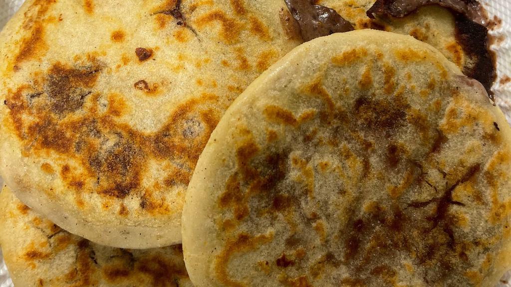 Pupusa Con Frijol Y Queso · A small-grilled tortilla stuffed with cheese and beans.