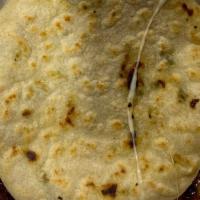 Pupusa Con Loroco Y Queso · A small-grilled tortilla stuffed with loroco flowers and cheese.