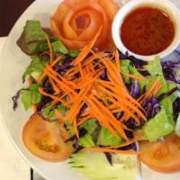 House Salad · Lettuce, cucumber, cabbage, tomato, carrots and served with a Thai peanut dressing.