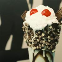 Mothman · Mint chocolate ice cream with a chocolate frosted rim covered in Andes mint candy topped wit...