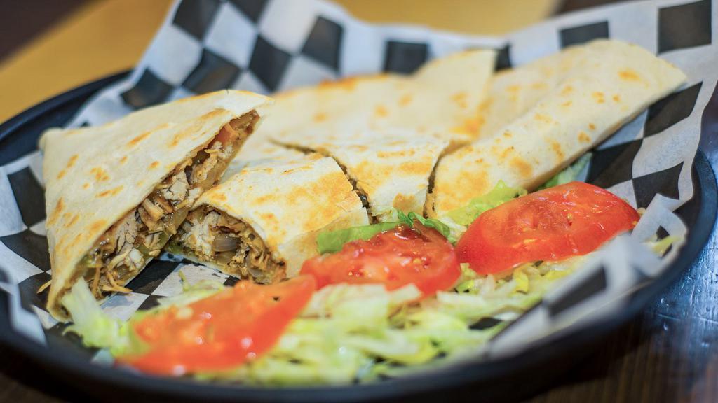 Chicken Quesadilla · Stuffed with grilled chicken, green peppers, onions, and mixed cheese. Served with a side of sour cream and salsa.