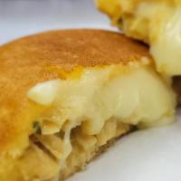 Arepita De Pollo Y Queso  · Corn fritter filled with mozzarella cheese and  shredded chicken