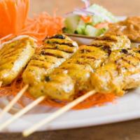 👍 Chicken Satay · Skewered Chicken white meat marinated in coconut satay curry served with peanut sauce and cu...