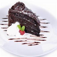 Chocolate Cake · Three layered chocolate cake topped with whipped cream and fresh raspberries.