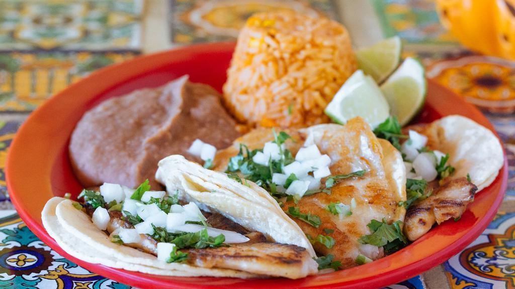 Fish Tacos · Three tilapia tacos topped with onions and cilantro. Serve with rice and beans. Your choice of corn or flour tortillas. The tilapia is cooked in the griddle with a little of oil.