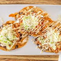 Tostadas · Three flat crispy shell tortilla topped with refried beans, lettuce, cream & cheese.