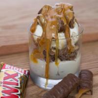 Great White Buffalo · Vanilla ice cream topped with chopped twix, caramel and chocolate syrup and peanut butter sh...