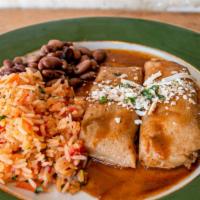 Pork Tamale Dinner · Gluten Free. Two tamales filled with spicy seasoned pork accompanied by Spanish rice and pin...