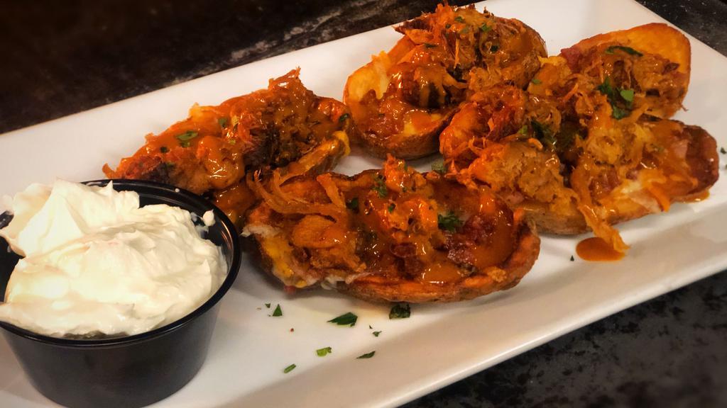 Potato Skins · Monterrey jack cheese, candied bacon, chives and sour cream.