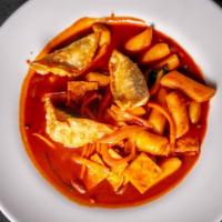 Dukboki · Rice cake, pork dumpling, vegetable and clear noodles in spicy sauce.
