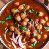 Panjabi Chole (V) · Vegan, gluten-free. Garbanzo beans simmered in a tomato-onion gravy and flavored with spices.