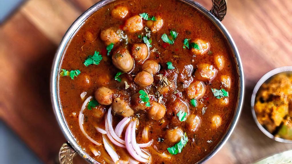 Panjabi Chole (V) · Vegan, gluten-free. Garbanzo beans simmered in a tomato-onion gravy and flavored with spices.