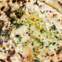 Garlic Naan (V) · Made with all-purpose white flour. White flour bread with garlic baked in our tandoor.