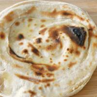 Tandoori Roti (V) · Made with whole wheat flour. Whole wheat unleavened bread baked in our day oven.